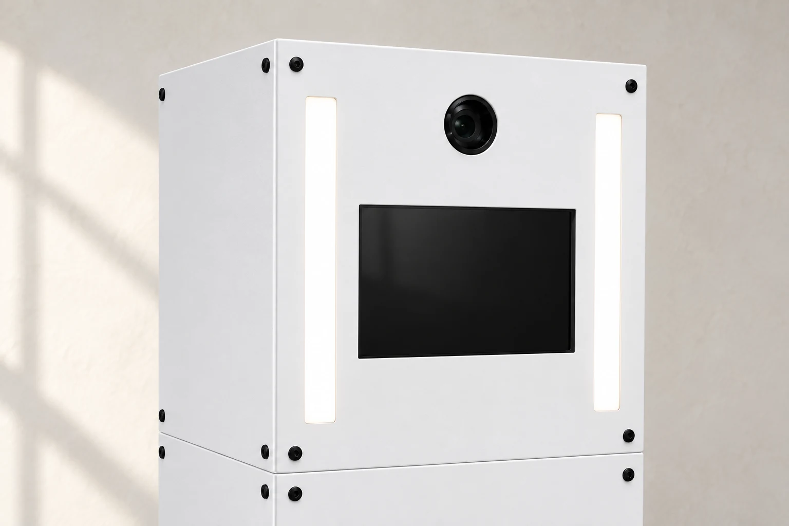 Camera lens, twin light bars and touchscreen set into the matte white booth